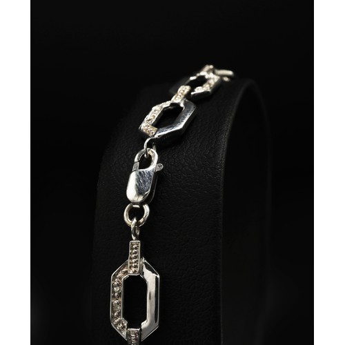 64 - A 9CT WHITE GOLD DIAMOND SET FANCY LINE BRACELET, with lobster claw clasp, the diamonds with a total... 