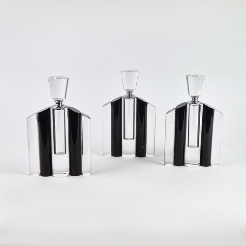 106 - A SET OF THREE ART DECO STYLE GLASS PERFUME BOTTLES, in clear and black glass, each measuring 24.5cm... 