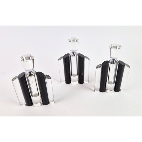 106 - A SET OF THREE ART DECO STYLE GLASS PERFUME BOTTLES, in clear and black glass, each measuring 24.5cm... 