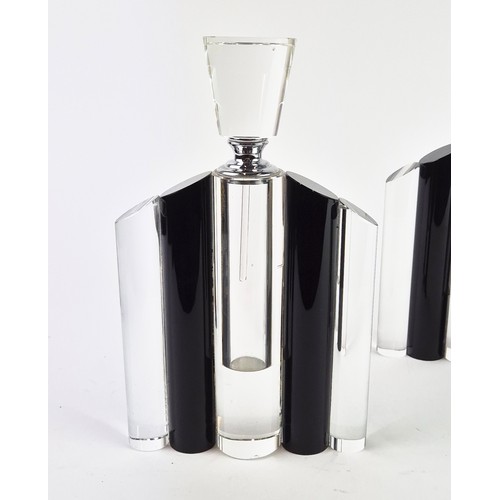 106 - A SET OF THREE ART DECO STYLE GLASS PERFUME BOTTLES, in clear and black glass, each measuring 24.5cm... 