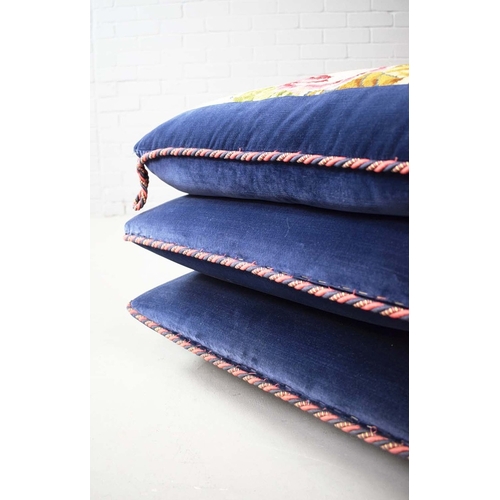 288 - NEEDLEWORK AND BLUE VELVET POUFFE. in the form of stacked cushions on castors, 41cm H 58cm W x 58cm ... 