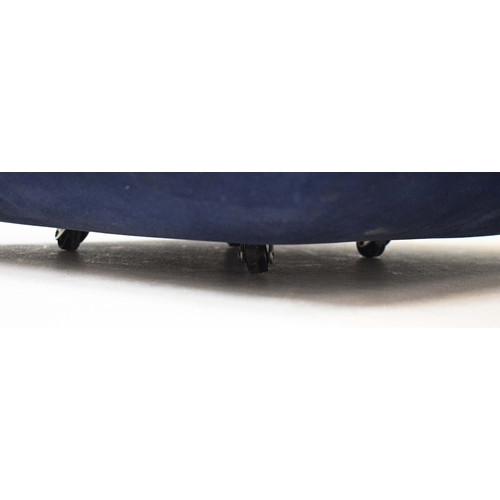 288 - NEEDLEWORK AND BLUE VELVET POUFFE. in the form of stacked cushions on castors, 41cm H 58cm W x 58cm ... 