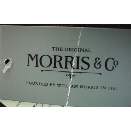 303 - WILLLIAM MORRIS POUFFES, A PAIR. bears label, each 51cm w x 35cm d.