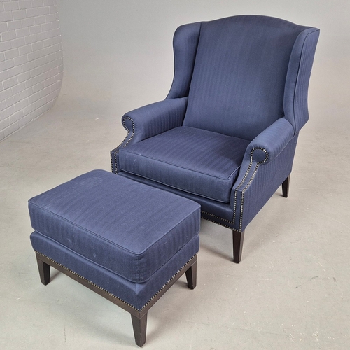 310 - WINGBACK CHAIR AND FOOTSTOOL (2). in blue herringbone fabric 76cm w x 103cm t and a small footstool ... 