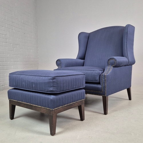 310 - WINGBACK CHAIR AND FOOTSTOOL (2). in blue herringbone fabric 76cm w x 103cm t and a small footstool ... 