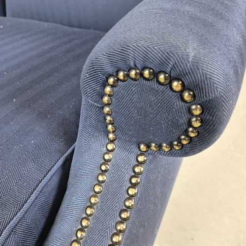 310 - WINGBACK CHAIR AND FOOTSTOOL (2). in blue herringbone fabric 76cm w x 103cm t and a small footstool ... 