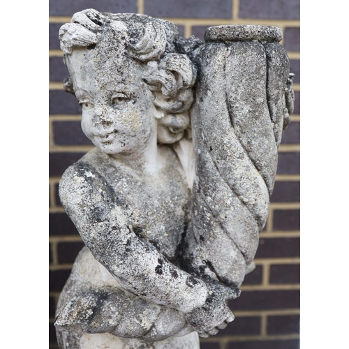 318 - WEATHERED STONE PUTTI (2). a pair.