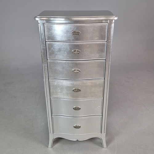 324 - SILVERED TALL CHEST. of serpentine form 65cm w x 46cm d x 137cm t.
