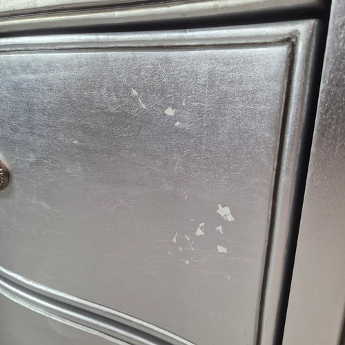 324 - SILVERED TALL CHEST. of serpentine form 65cm w x 46cm d x 137cm t.