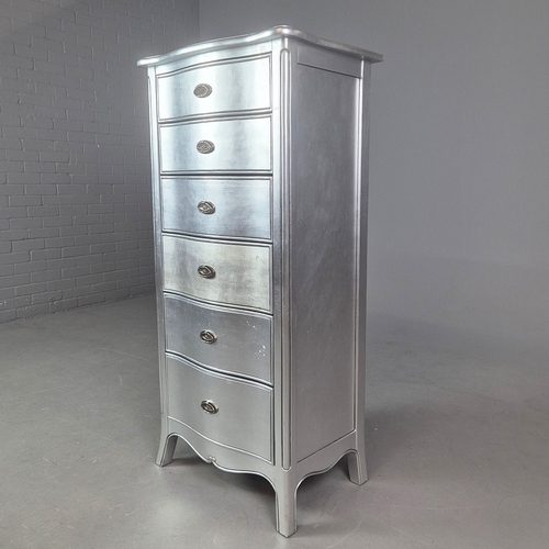 324 - SILVERED TALL CHEST. of serpentine form 65cm w x 46cm d x 137cm t.