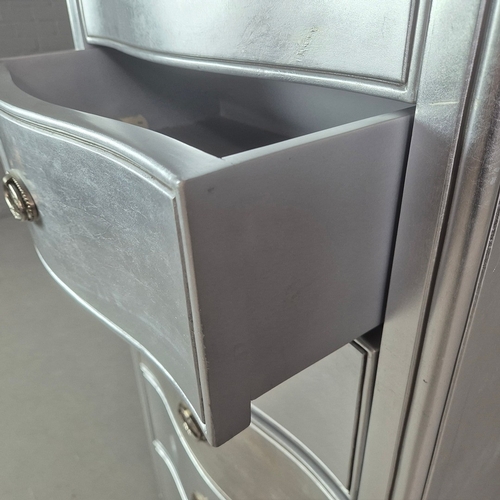 324 - SILVERED TALL CHEST. of serpentine form 65cm w x 46cm d x 137cm t.