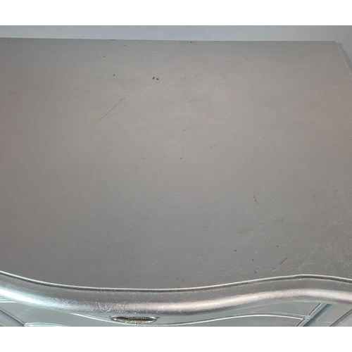 324 - SILVERED TALL CHEST. of serpentine form 65cm w x 46cm d x 137cm t.