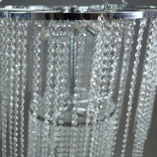342 - CHANDELIER. polished metal frame with drops hiding 2 tiered lighting.