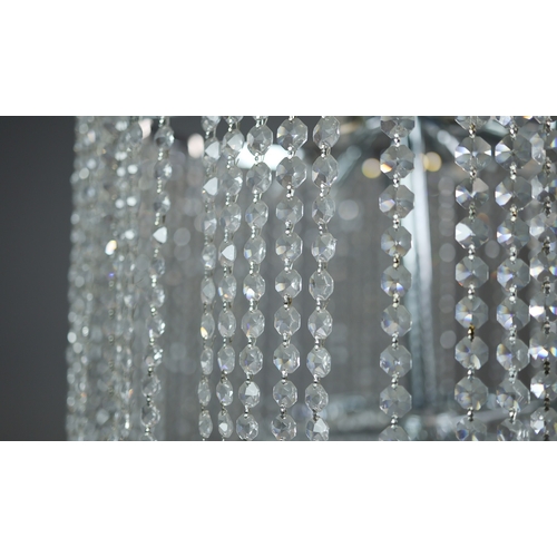 342 - CHANDELIER. polished metal frame with drops hiding 2 tiered lighting.