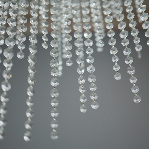 342 - CHANDELIER. polished metal frame with drops hiding 2 tiered lighting.