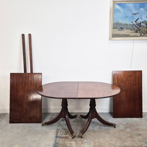 346 - DINING TABLE, REGENCY STYLE. mahogany, with two pedestals each with tripod supports, with two leaves... 