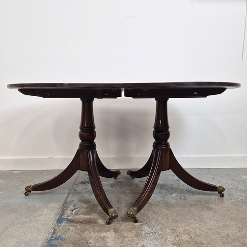 346 - DINING TABLE, REGENCY STYLE. mahogany, with two pedestals each with tripod supports, with two leaves... 