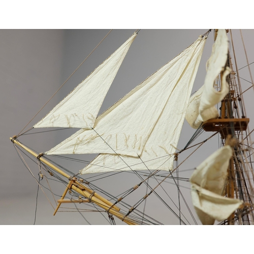 349 - MODEL OF A SQUARE RIGGED SHIP. on a small stand, plaque reads 