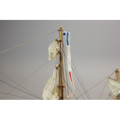 349 - MODEL OF A SQUARE RIGGED SHIP. on a small stand, plaque reads 