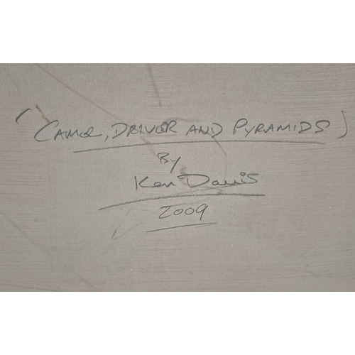 81 - KEN DAVIS. CAMEL DRIVER AND PYRAMIDS. oil on board, 50cm x 60cm, framed.