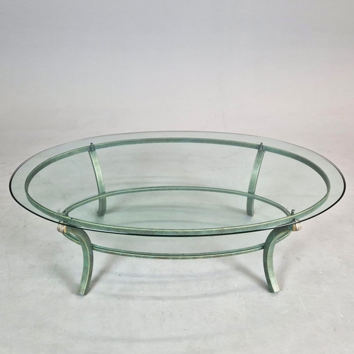 695 - PIERRE VANDAL COFFEE TABLE. the oval glass top on a verdigris base 80cm w x 46cm d x 136cm w.