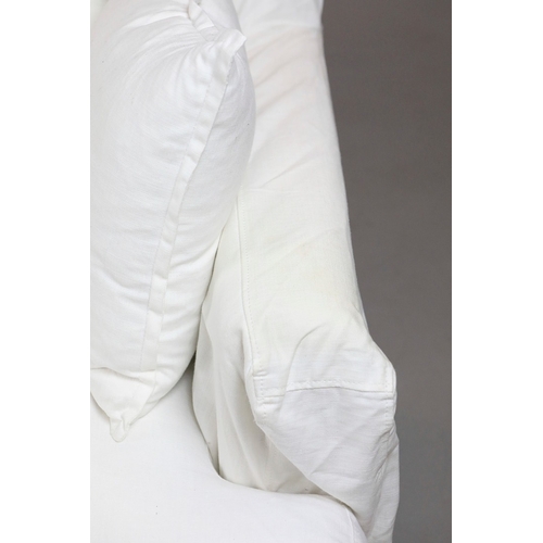 711 - SOFA, WHITE. in a loose cover, comes in two sections 87cm d x 220cm l x 86cm t.