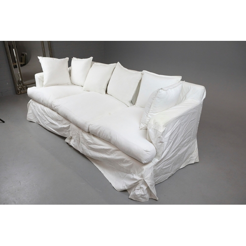 711 - SOFA, WHITE. in a loose cover, comes in two sections 87cm d x 220cm l x 86cm t.
