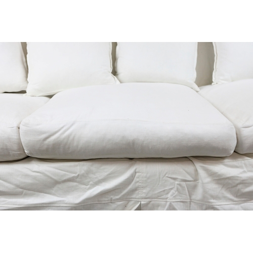711 - SOFA, WHITE. in a loose cover, comes in two sections 87cm d x 220cm l x 86cm t.
