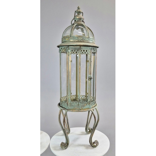 730 - PAIR OF LANTERNS ON STANDS IN VERDIGRIS FINISH METAL AND GLASS. 80cm H x 28cm W.