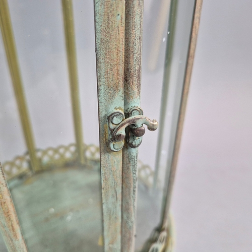 730 - PAIR OF LANTERNS ON STANDS IN VERDIGRIS FINISH METAL AND GLASS. 80cm H x 28cm W.