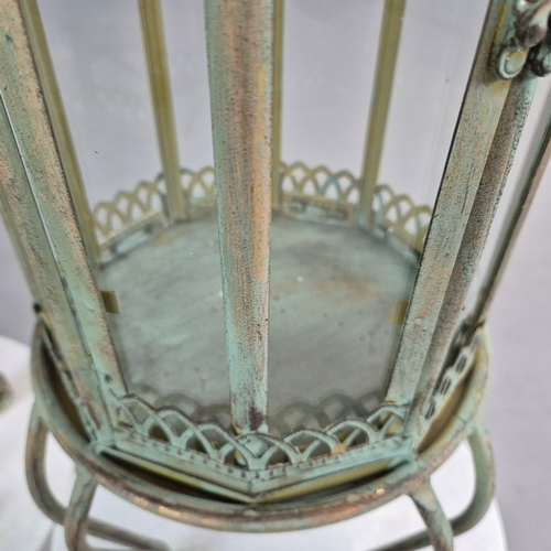 730 - PAIR OF LANTERNS ON STANDS IN VERDIGRIS FINISH METAL AND GLASS. 80cm H x 28cm W.