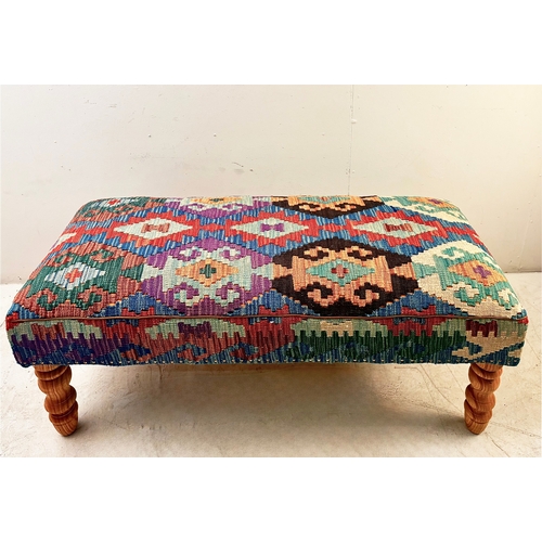 23 - HEARTH STOOL WITH KILIM UPHOLSTERY ON TURNED SUPPORTS. 52cm H x 123cm W x 50cm D.