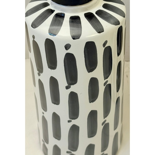 34 - PAIR OF BLACK AND WHITE CERAMIC LIDDED JARS. 45cm H x 14cm W.