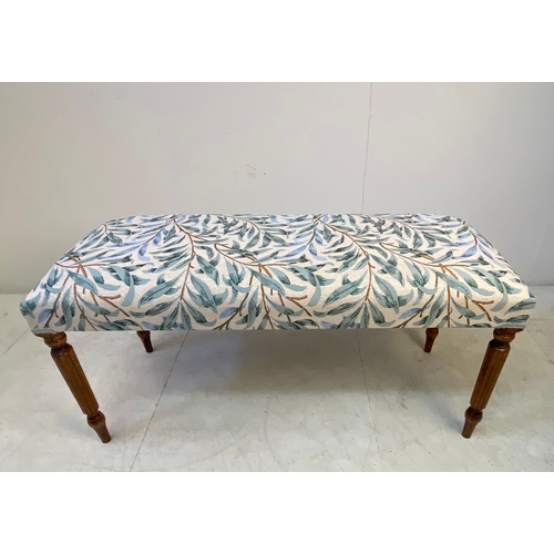 37 - LONG STOOL WITH BOTANICAL DESIGN UPHOLSTERY ON REEDED SUPPORTS. 47cm H x 100cm W x 40cm D.