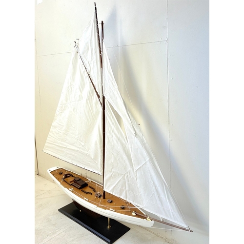 38 - MODEL SAILING BOAT ON STAND. 150cm H x 135cm W x 21cm D.