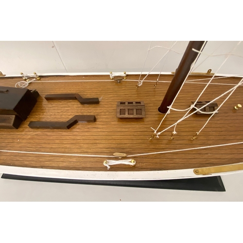 38 - MODEL SAILING BOAT ON STAND. 150cm H x 135cm W x 21cm D.