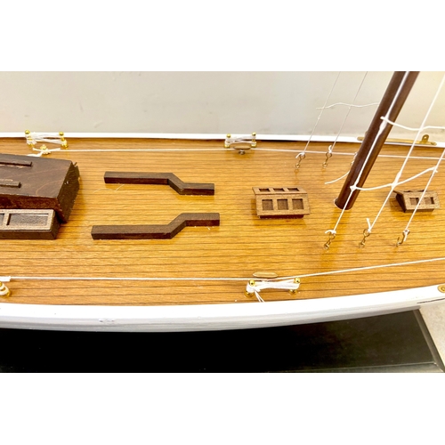 38 - MODEL SAILING BOAT ON STAND. 150cm H x 135cm W x 21cm D.