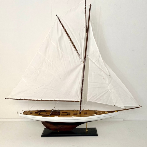 38 - MODEL SAILING BOAT ON STAND. 150cm H x 135cm W x 21cm D.