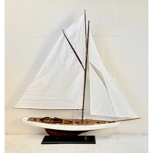 38 - MODEL SAILING BOAT ON STAND. 150cm H x 135cm W x 21cm D.