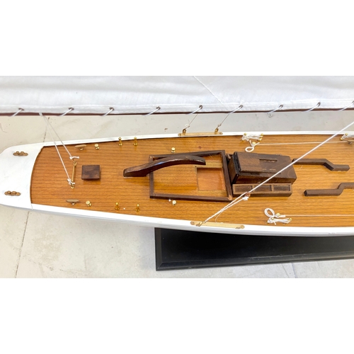 38 - MODEL SAILING BOAT ON STAND. 150cm H x 135cm W x 21cm D.