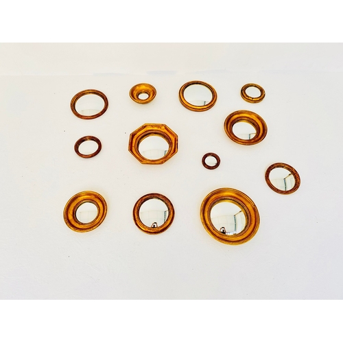 57 - SET OF TWELVE CONVEX MIRRORS WITH GILT FRAMES. various sizes and designs,  26cm diam. at largest app... 