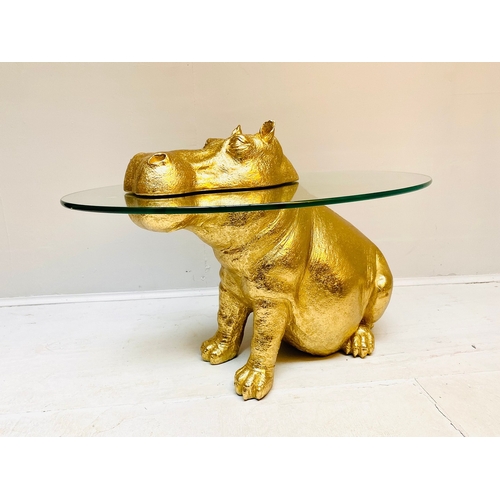 66 - HIPPO LOW TABLE IN A GILT FINISH WITH GLASS TOP. 65cm H x 120cm W x 50cm D.