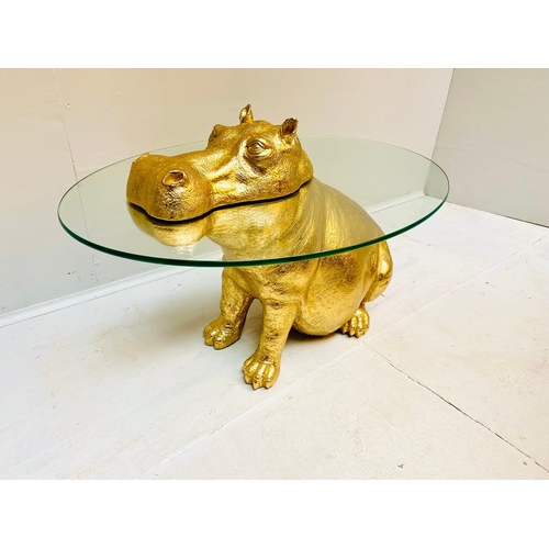 66 - HIPPO LOW TABLE IN A GILT FINISH WITH GLASS TOP. 65cm H x 120cm W x 50cm D.