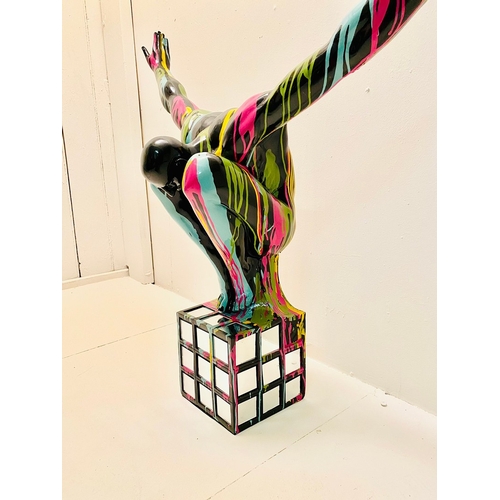 72 - CONTEMPORARY DIVER SCULPTURE IN PAINT SPLATTERED FINISH. 81cm H x 82cm W x 28cm D.