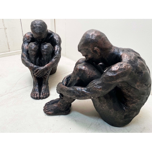 76 - PAIR OF SITTING MAN SCULPTURES IN BRONZED FINISH RESIN. 34cm H x 21cm W x 49cm D.