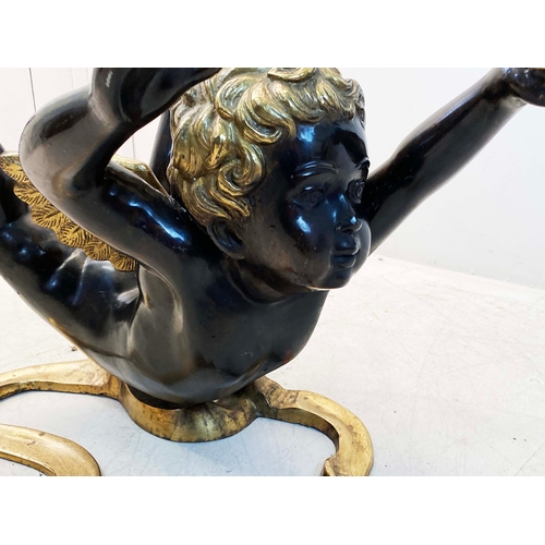 77 - CHERUB COFFEE TABLE WITH GLASS TOP ON PAINTED METAL BASE. 40cm H x 60cm W.