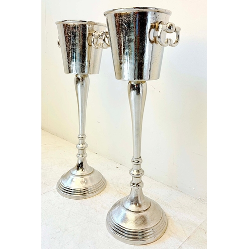 78 - PAIR OF POLISHED METAL WINE COOLERS ON STANDS. 77cm H x 30cm W x 24cm D.