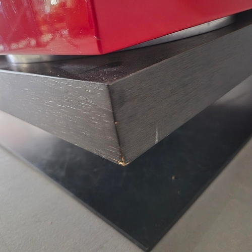 284 - LIGNE ROSET STRATES RED AND BLACK COFFEE TABLE. The top two tiers rotate
35cm H x 80cm W x 80cm D.