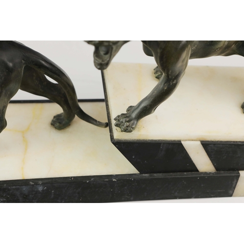 5 - A FRENCH ART DECO LION AND LIONESS SCULPTURE. in spelter on stepped black and white marble base. 85c... 