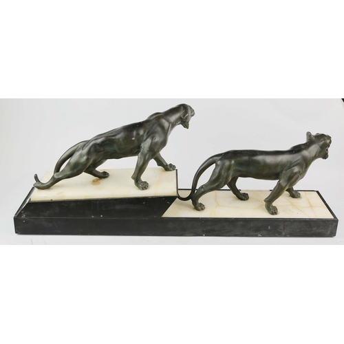 5 - A FRENCH ART DECO LION AND LIONESS SCULPTURE. in spelter on stepped black and white marble base. 85c... 